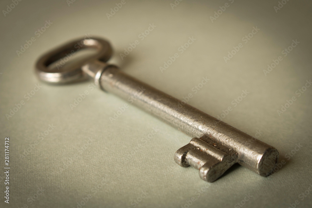 Old key on grey background. Key isolated on grey background. Old key on grey background. Key isolated on grey background.