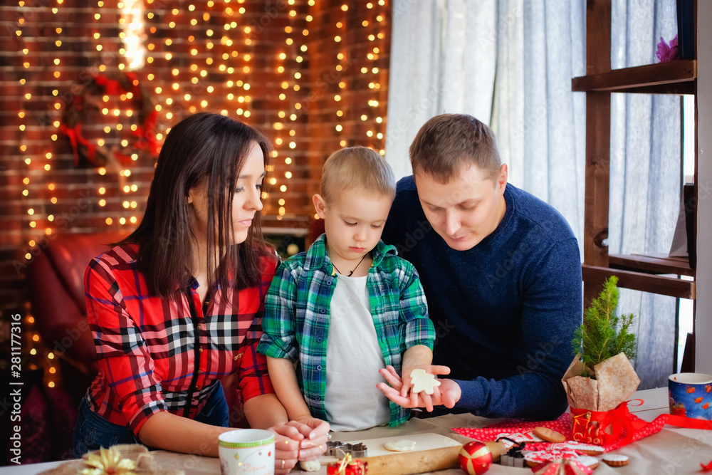 Fototapeta premium happy family prepares Christmas cookies for Christmas