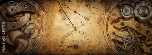 The dials of the old antique classic clocks on a vintage paper background. Concept of time, history, science, memory, information. Retro style. Vintage clockwork background.