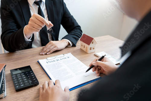 Real Estate broker or sale agent giving consultation to customer about buying house sign agreement document contract. Home loan.