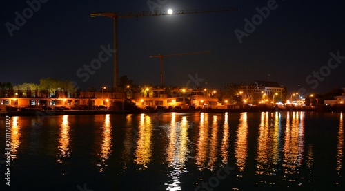 the city lights reflected in the water at night