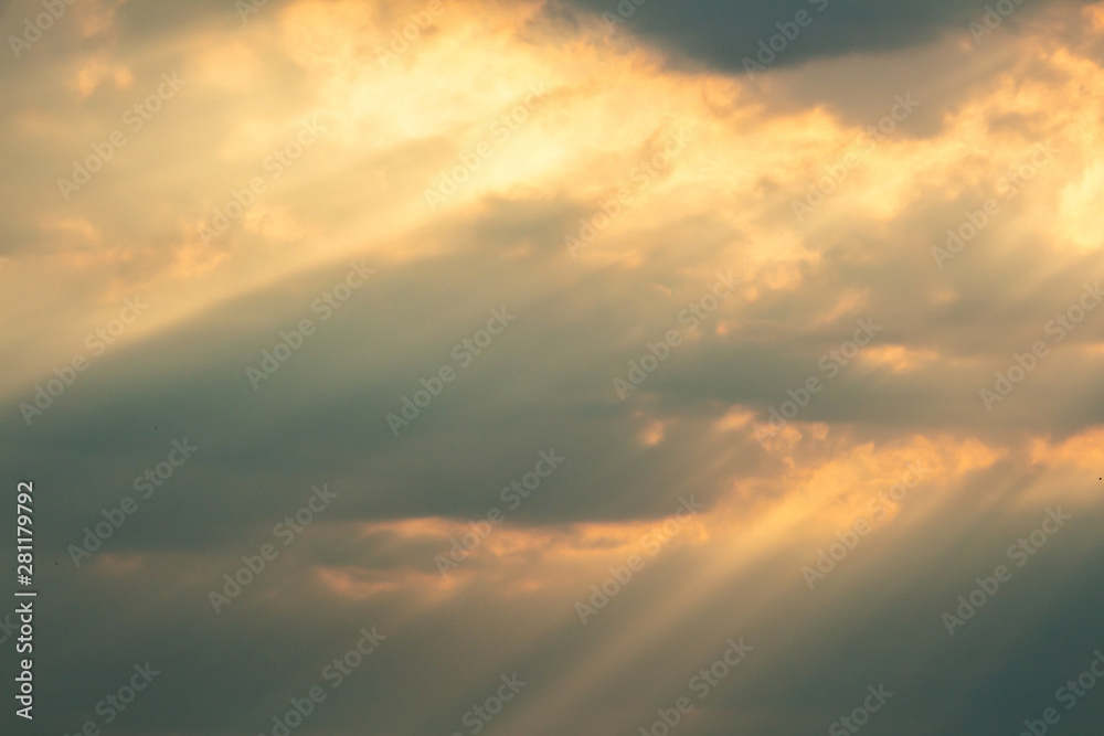 Dramatic picturesque colorful skies with cloud and picturesque sunbeams before sunset