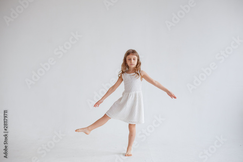 girl in white dress dancing on white background