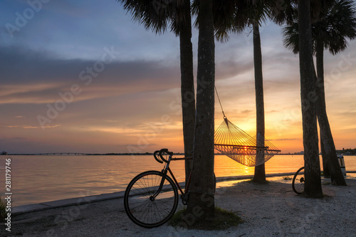 Fototapeta Naklejka Na Ścianę i Meble -  The hammock at palm trees at Sunset in Siesta Key beach, Sarasota, Florida
