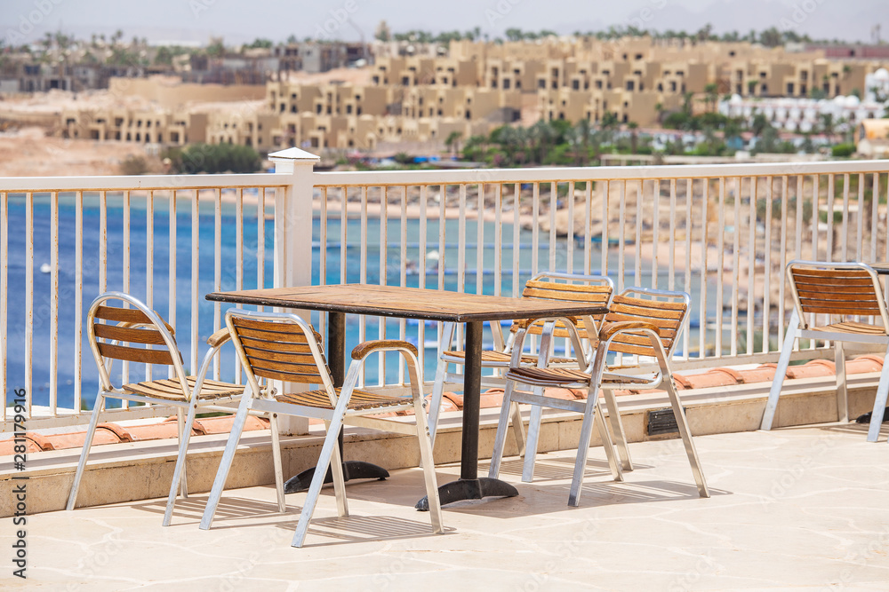 Fototapeta premium Table and chairs in beach cafe next to the red sea in Sharm el Sheikh, Egypt