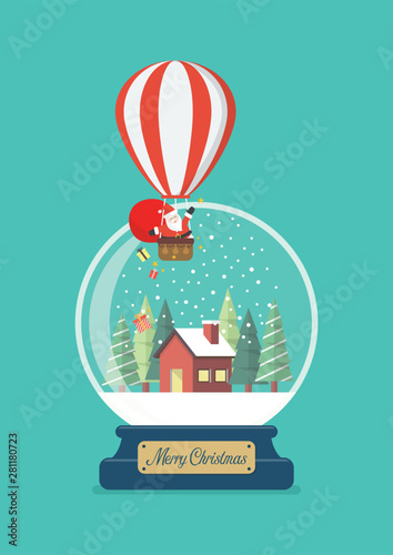 Merry christmas glass ball with Santa in balloon and winter house