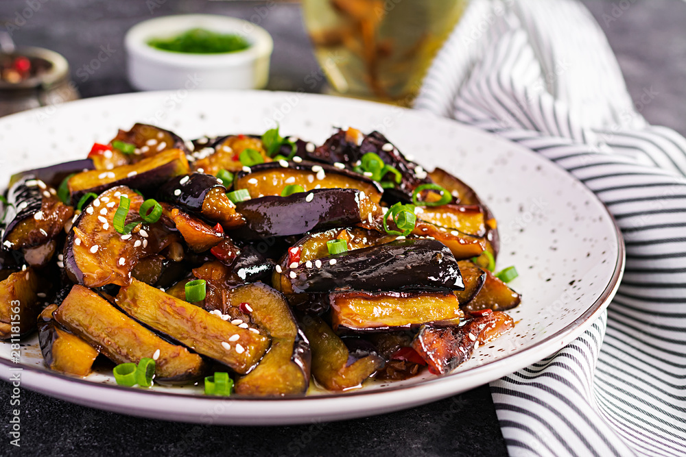 Hot spicy stew eggplant in Korean style with green onion. Aubergine saute. Vegan food.