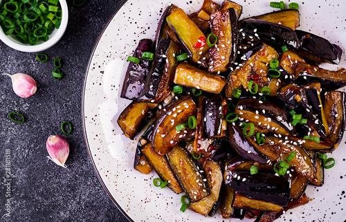 Hot spicy stew eggplant in Korean style with green onion. Aubergine saute. Vegan food. Top view