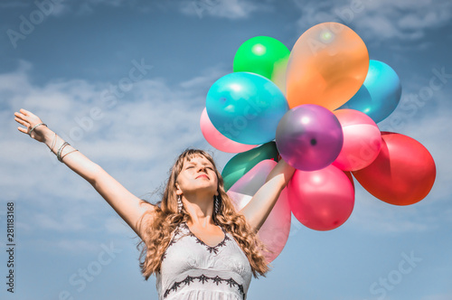 Girl playing with colorful balloons