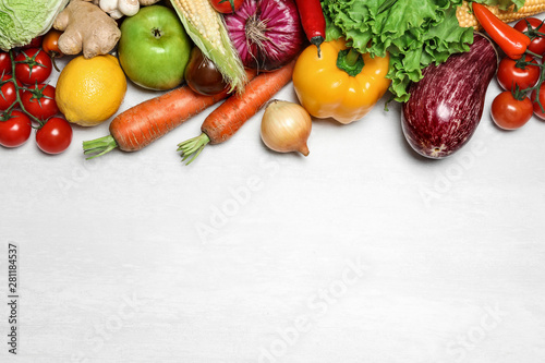 Different fresh vegetables on light table, flat lay. Space for text