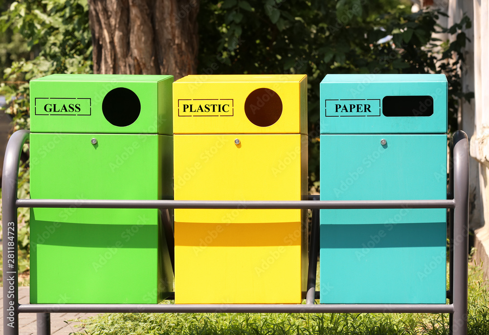 Waste sorting bins on city street. Recycling concept Stock Photo