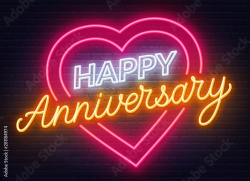 Happy anniversary neon sign. Greeting card on dark background.