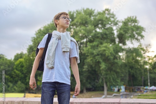 Outdoor portrait of teenager boy with glasses backpack