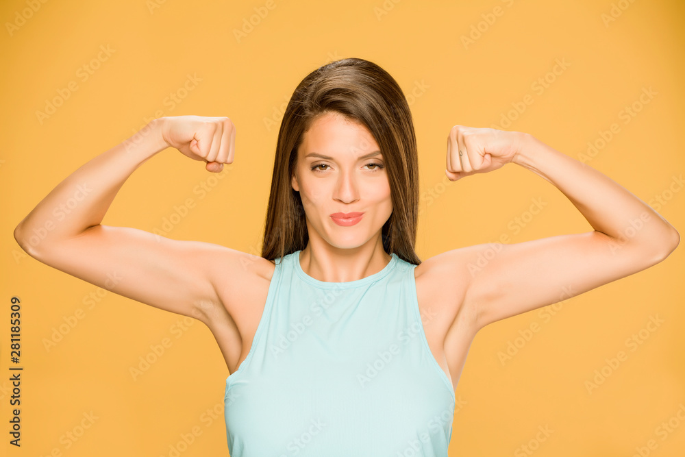 Young smiling woman showing her hands on yellow background Young smiling woman showing her hands on yellow background