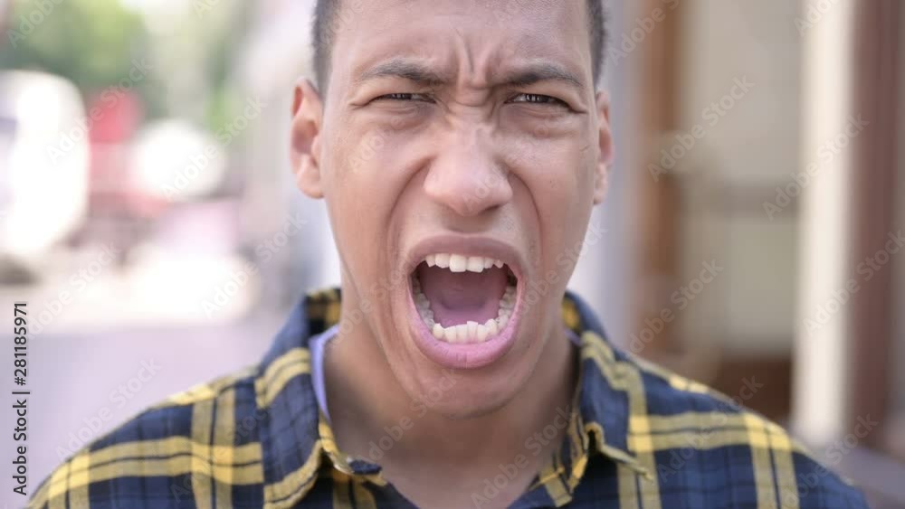 Close up of Wondering Young African Man in Shock, Outdoor Close up of Wondering Young African Man in Shock, Outdoor