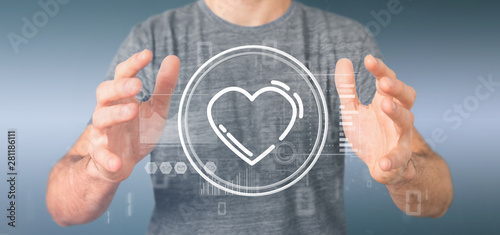 Obraz na plátně Businessman holding a heart icon surrounded by data