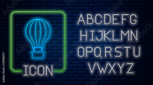 Glowing neon Hot air balloon icon isolated on brick wall background. Air transport for travel. Neon light alphabet. Vector Illustration