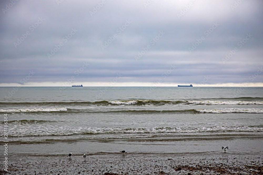 Distant cargo ships and low-level cloud Distant cargo ships and low-level cloud