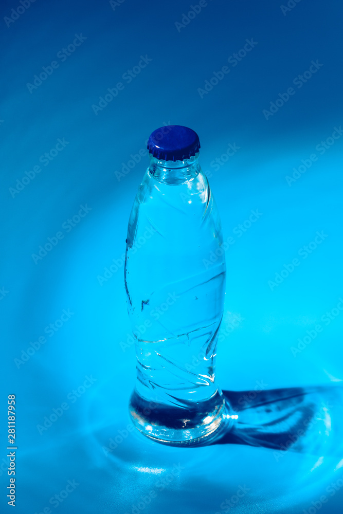 Water bottle close up on dark blue background Water bottle close up on dark blue background