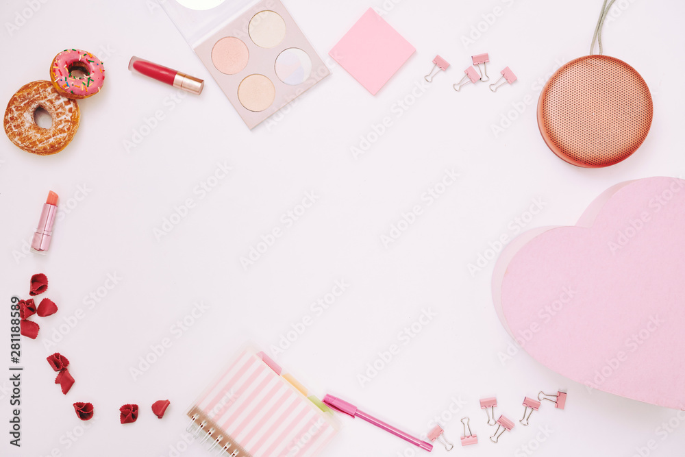 Image of office supplies lipstick and sweet food in pink color on white background