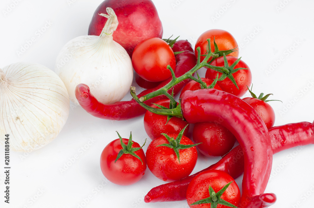 Red tomatoes and peppers on a white background Red tomatoes and peppers on a white background