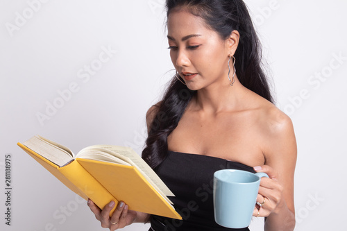 Young Asian woman with a book and cup of coffee.