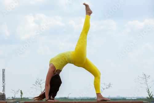 Yoga exercise - woman doing yoga pose meditation in the public park sport healthy concept.
