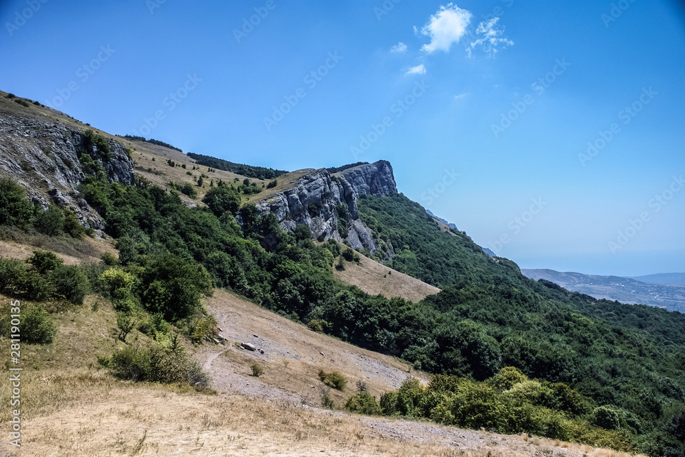  The mountains with a cloud overhead.Landscape of mountains and rocks. Green nature of stone mountain. Natural beauty. Nature of Crimea. Ukraine