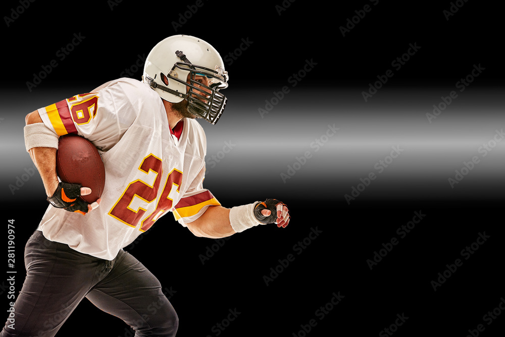 American football player in motion with the ball on a black background with a light line, copy space. The concept of the game is American football, movement. American football player in motion with the ball on a black background with a light line, copy space. The concept of the game is American football, movement.