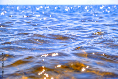 Shine of sea waves. Blue sea water surface. Reflection of sunlight in the water surface.