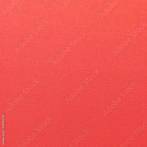 Textured wallpaper with a pattern on a wall. Shade of red, coral color background.
