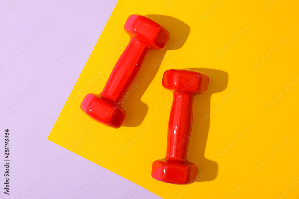 Dumbbells for fitness on two tone background, space for text Dumbbells for fitness on two tone background, space for text