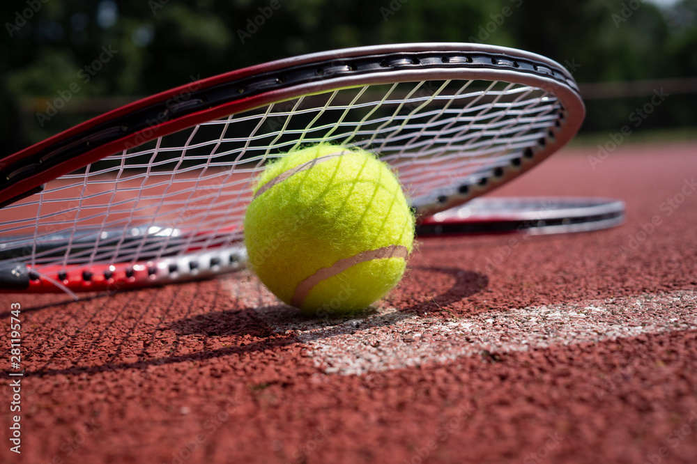 Close-up tennis rocket over balls