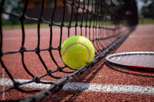 Detail of single tennis ball on black net © NetPix