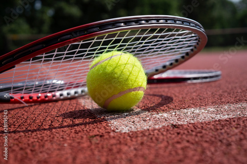 Close-up tennis rocket over balls