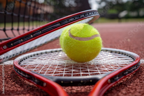 Tennis ball resting on top of tennis racquet © NetPix