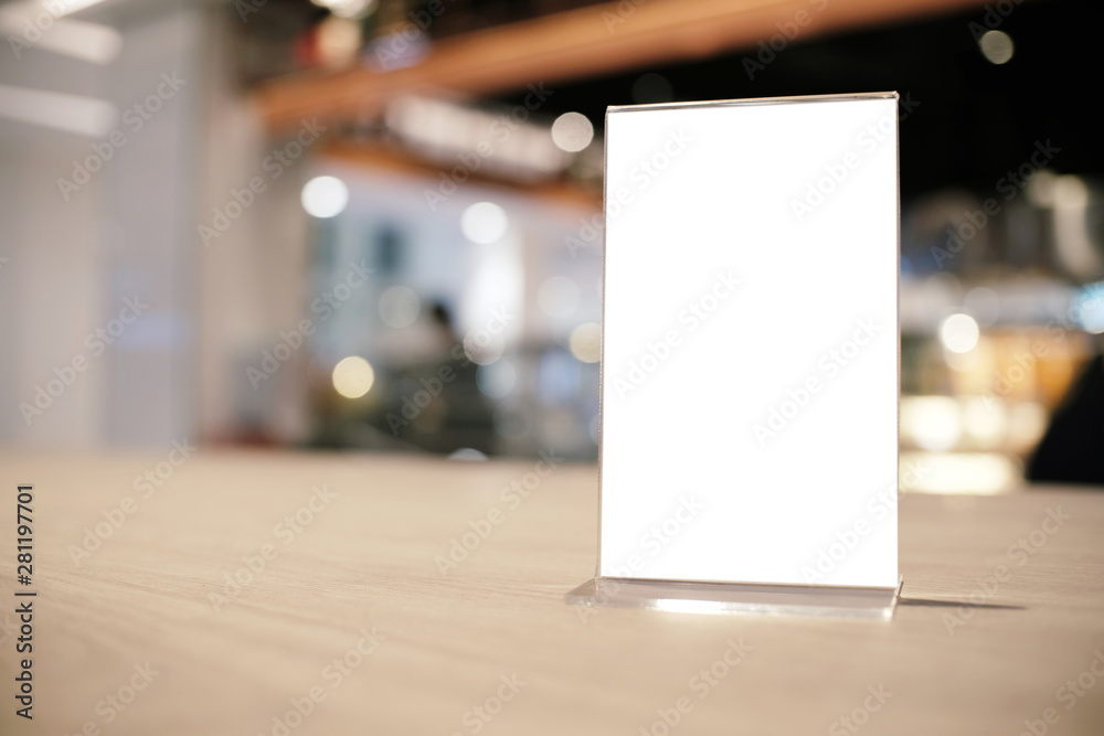 Mock up Menu frame standing on wood table in Bar restaurant cafe. space for text