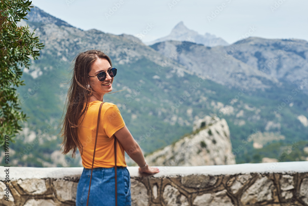 Young woman against a beautiful view to the rocks and mountains in Guadalest.