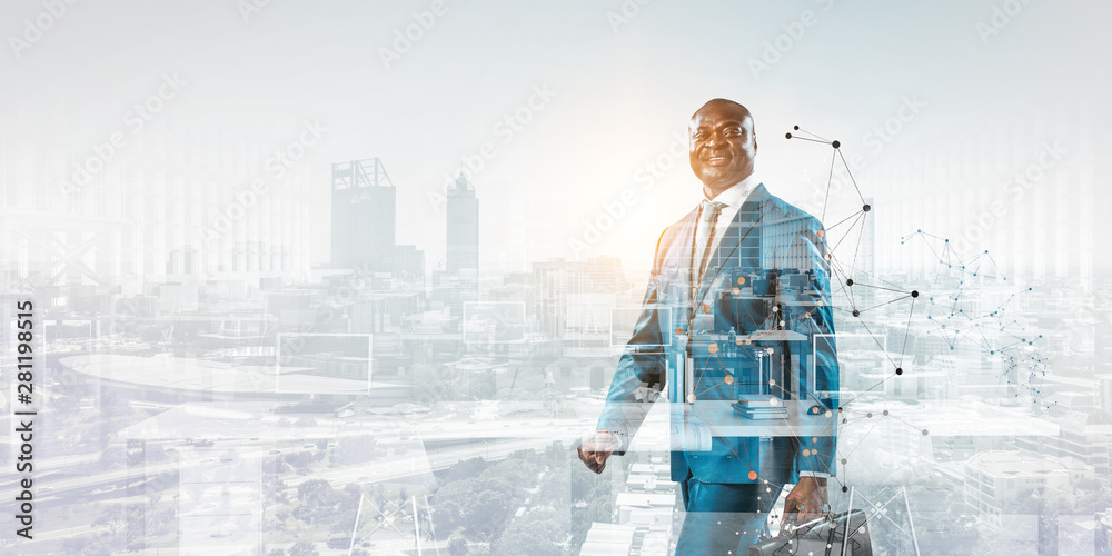 © Sergey Nivens - Smiling black businessman standing against a cityscape and graphic background
