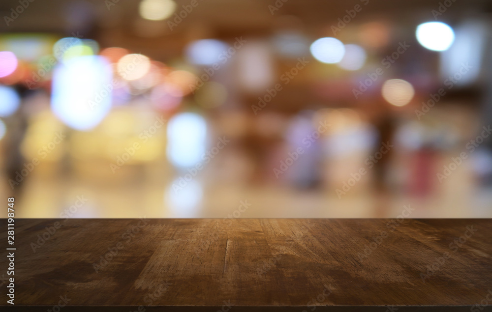 Empty dark wooden table in front of abstract blurred bokeh background of restaurant . can be used for display or montage your products.Mock up for space. Empty dark wooden table in front of abstract blurred bokeh background of restaurant . can be used for display or montage your products.Mock up for space.