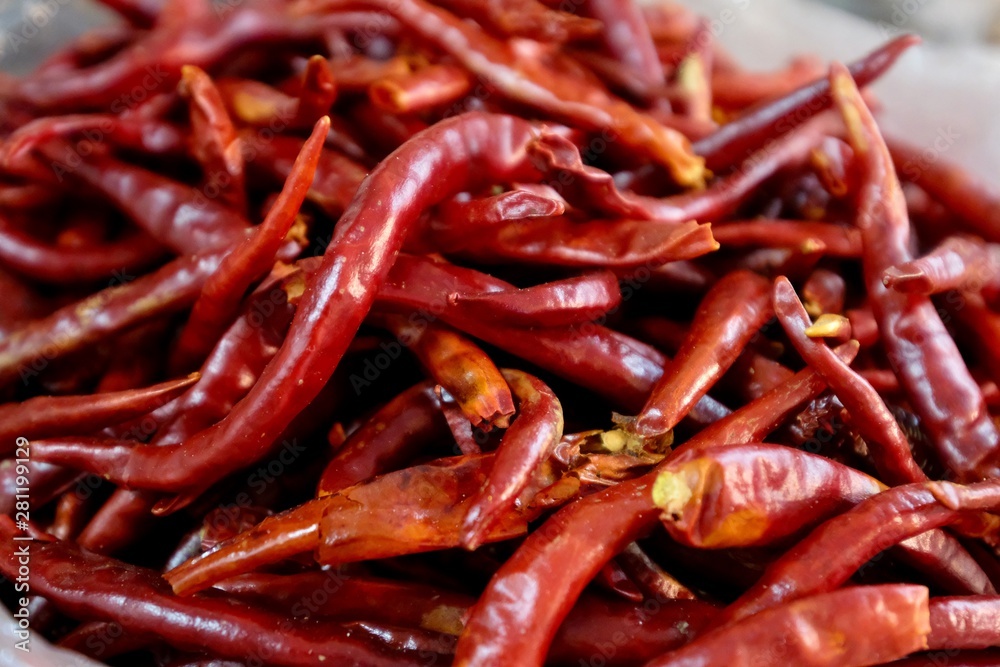 Close up a heap of fresh dry red peppers ( dried chilli ) under natural daylight. Soft focus
