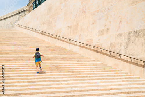 Child running in empty city