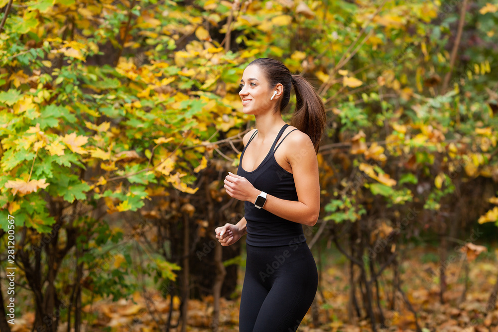 Healthy lifestyle. Woman jogging on forest trail Healthy lifestyle. Woman jogging on forest trail