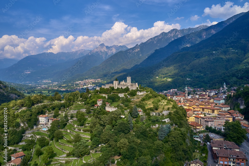 Aerial photography, castle of Breno in the province of Brescia, Lombardy region. The castle is located on a mountain surrounded by the Alps in the background the city of Breno in the north of Italy.