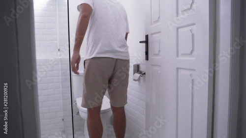 back portrait of man's gesture peeing in a toilet