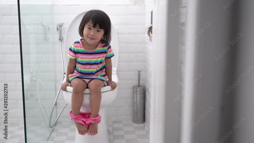pooping in the toilet. cute asian kid push it hard while sitting on toilet Stock ビデオ | Adobe Stock 