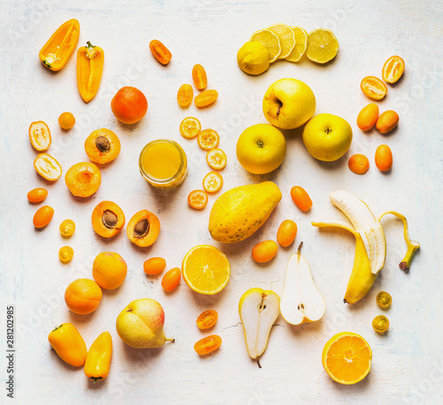 Fototapeta Naklejka Na Ścianę i Meble -  Various yellow and orange color fruits and vegetables on white table background. Flat lay. Food layout. Color diet. Benefits of yellow and orange color food. Healthy eating