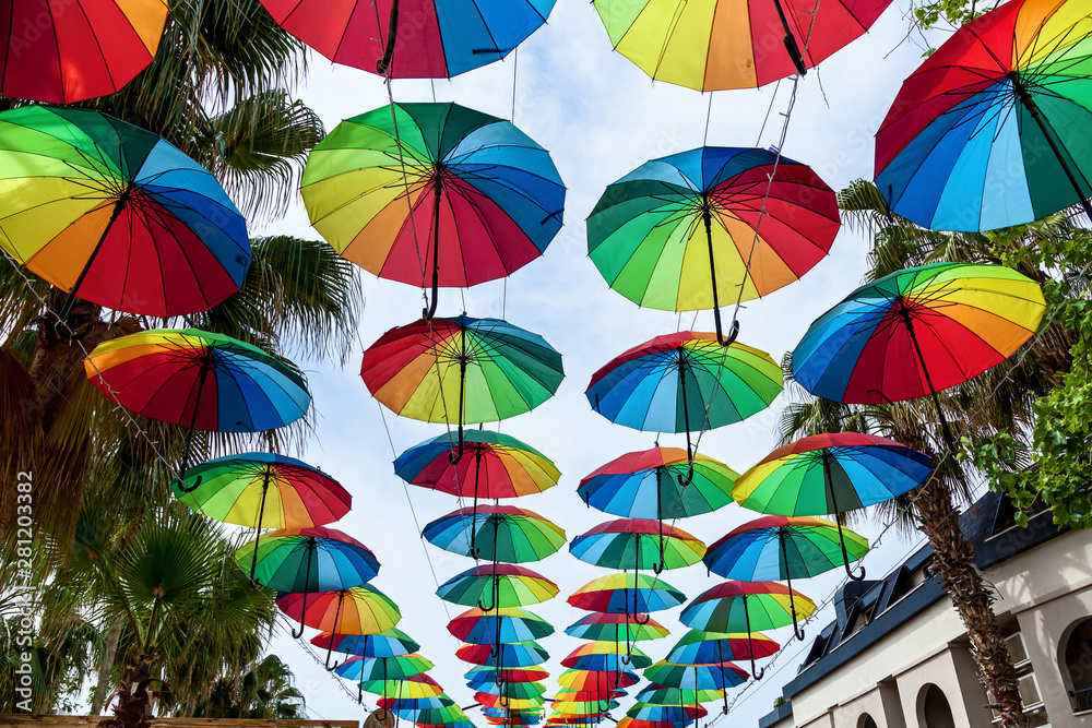 Colourful umbrellas danging the street