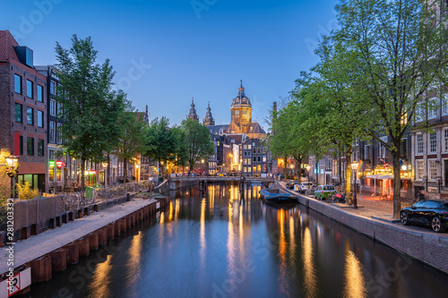 Night in Amsterdam city with Saint Nicholas Church at night in Amsterdam, Netherlands
