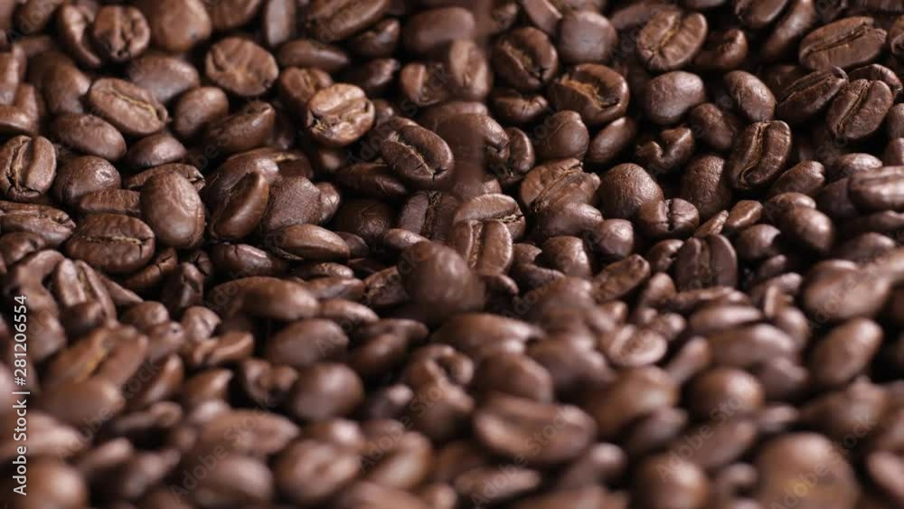 Roasted coffee bean. Fragrant coffee beans scrolls slowly around the camera. Slow Motion Close Up of Whole Roasted Coffee Beans. Roasted coffee bean. Fragrant coffee beans scrolls slowly around the camera. Slow Motion Close Up of Whole Roasted Coffee Beans.